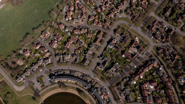 Aerial photo of the village of Caldecotte in Milton Keynes UK showing a typical British housing estate on a sunny summers day taken with a drone from above