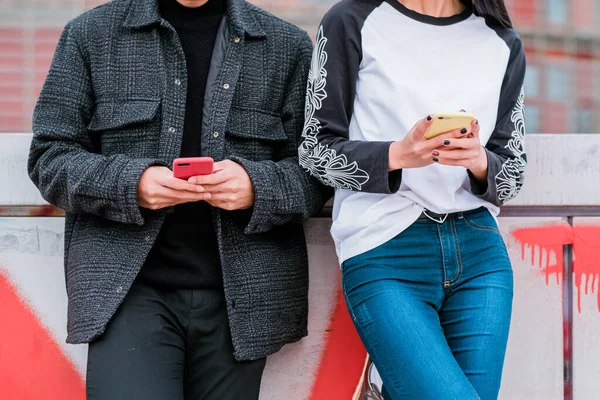 Happy young asian couple using smartphone on city street — Foto Stock