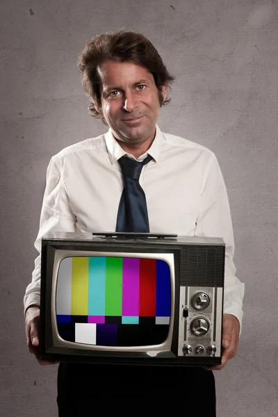 Businessman holding old retro television — Stock Photo, Image