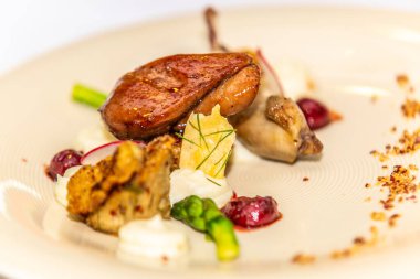 Karamelli kaz ciğeri. Tabağında da meze var. Yemek tasarımı ve restoran yemeği.