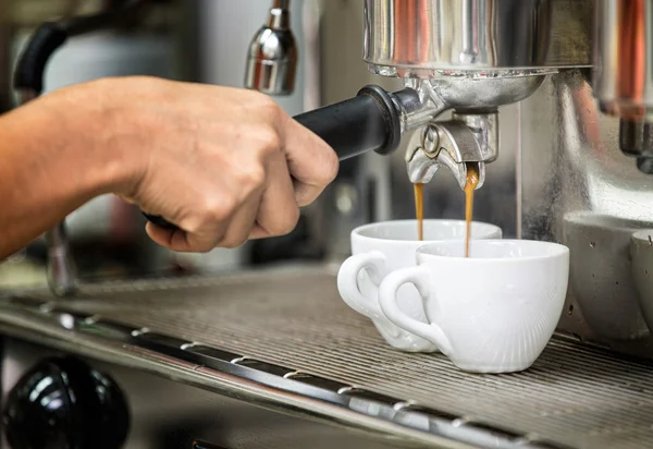 Prepares espresso in his coffee shop — Stock Photo, Image