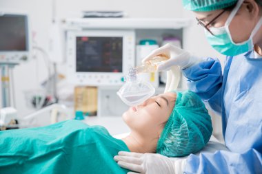 Young female patient receiving artificial ventilation  clipart