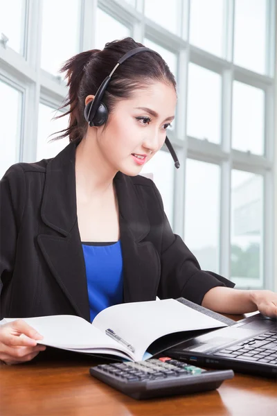 Friendly asian female helpline operator with headphones — Stock Photo, Image