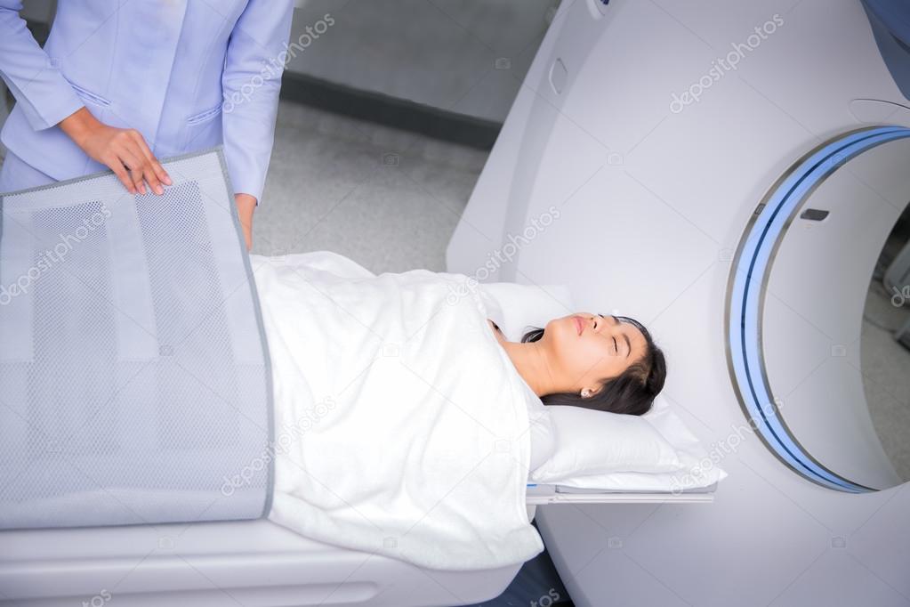 Asian lady sleep on a CT Scan bed 