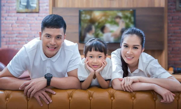 Happy young family wathching flat tv — Stock Photo, Image