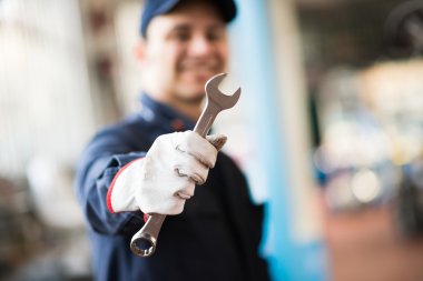 mechanic holding wrench