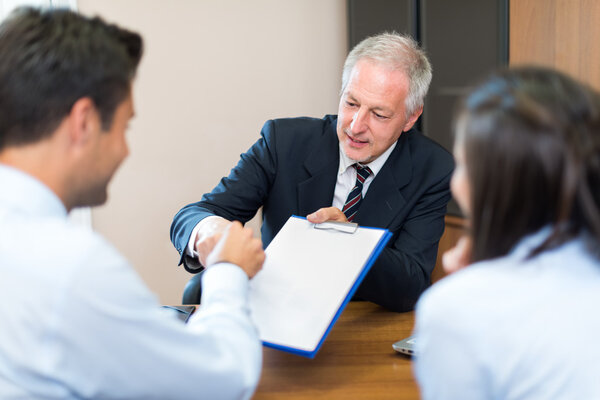 Businessman talking to couple