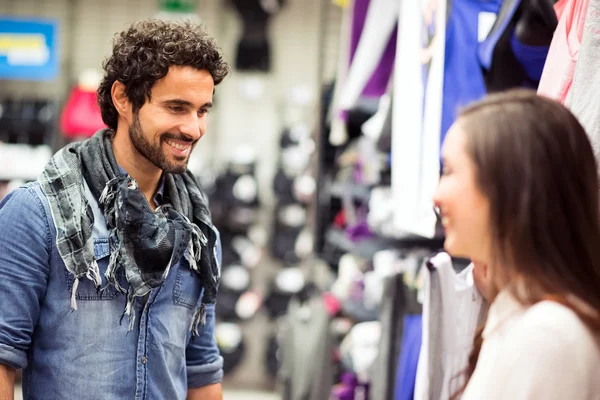 Couple shopping in dress shop — Stock Photo, Image