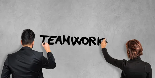 Business people writing word Teamwork