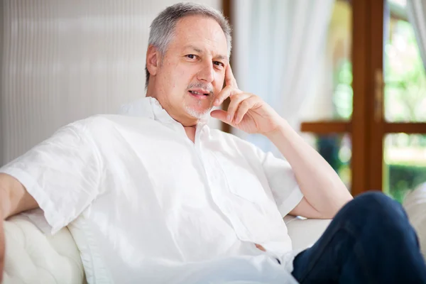 Mature man relaxing on couch — Stock Photo, Image