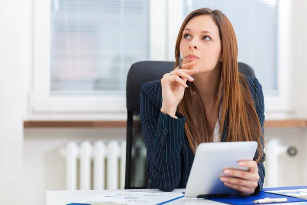 Businesswoman using tablet in office — Stock Photo, Image