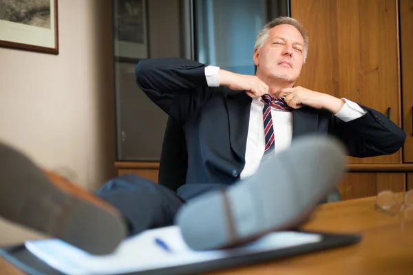 Businessman relaxing on chair — Stock Photo, Image