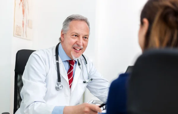 Médico conversando com paciente em estúdio — Fotografia de Stock