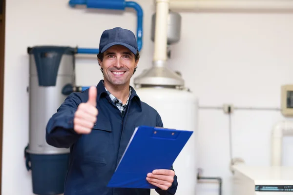 Technician servicing hot-water heater — Stock Photo, Image