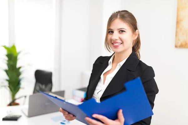 Sorrindo empresária segurando prancheta — Fotografia de Stock