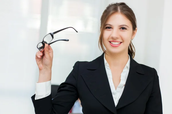 Woman holding her eyeglasses — Stock Photo, Image