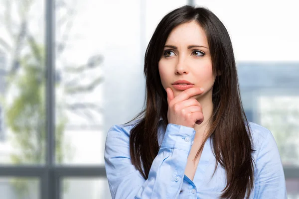 Woman in pensive expression in office — Stock Photo, Image