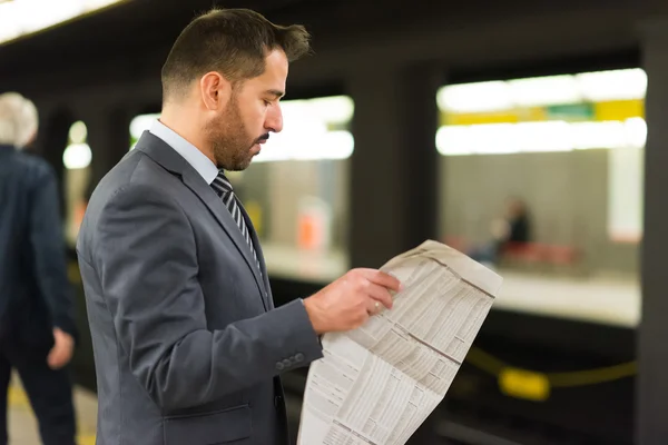 Commuter reading a newspaper — Stock Photo, Image