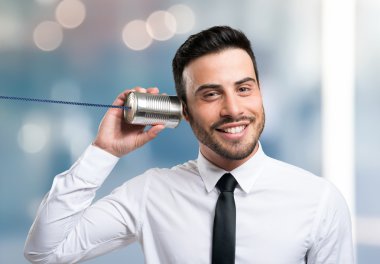 Bir teneke kutu telefonda konuşurken işadamı