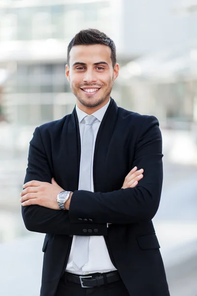 Handsome businessman in urban scene — Stock Photo, Image