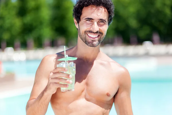 Handsome young man drinking a cocktail — Stock Photo, Image