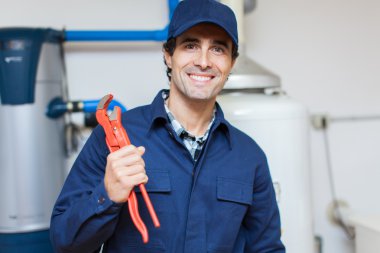 plumber repairing an hot-water heater clipart