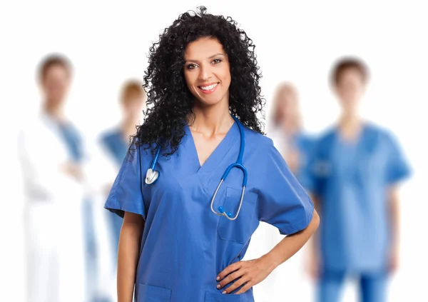 Smiling nurse in front of team — Stock Photo, Image