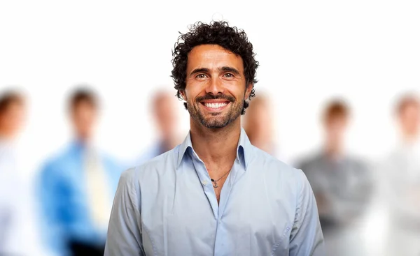 Young man in front of a group of people — Stock Photo, Image