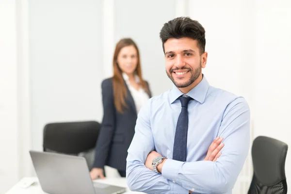 Glimlachende zakenman in zijn kantoor — Stockfoto