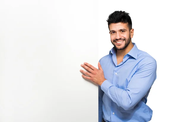 Smiling businessman holding white board — Stock Photo, Image