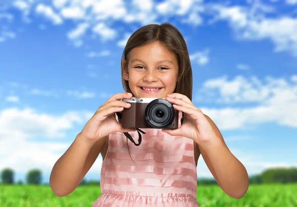 Child holding a compact camera — Stock Photo, Image