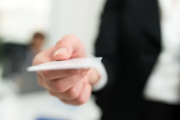 Businesswoman giving a business card — Stock Photo, Image