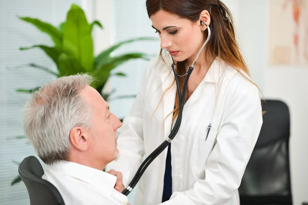 Doctor hearing patients heartbeat — Stock Photo, Image