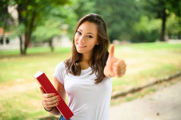 Beautiful Female Student Holding Book Outdoor Giving Thumbs — Stock Photo, Image