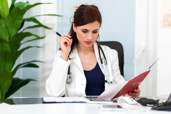 Femme Médecin Lecture Dossier Patient Sur Presse Papiers Dans Bureau — Photo