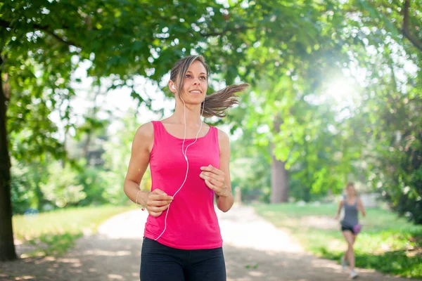 公園でジョギングする若い女性 — ストック写真
