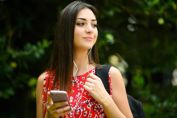 Ženské Studentky Procházky Parku Zatímco Pomocí Svého Smartphonu Poslouchat Hudbu — Stock fotografie