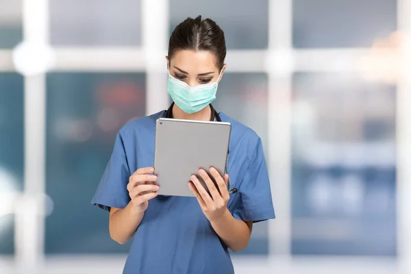 Young nurse using a mobile tablet app