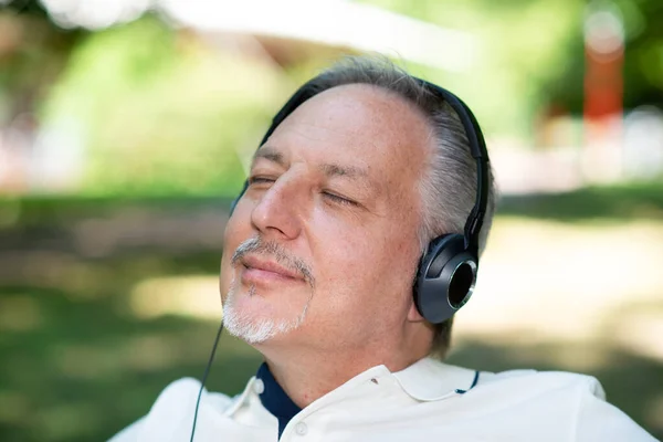 Mature Man Listening Music Park Closed Eyes — Stock Photo, Image