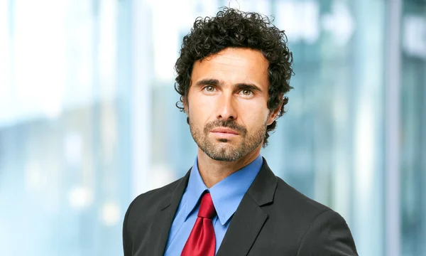 Handsome businessman in city — Stock Photo, Image