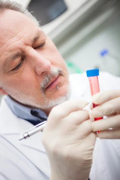 Scientis writing on test tube — Stock Photo, Image