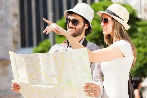 Pareja de turistas sosteniendo mapa — Foto de Stock