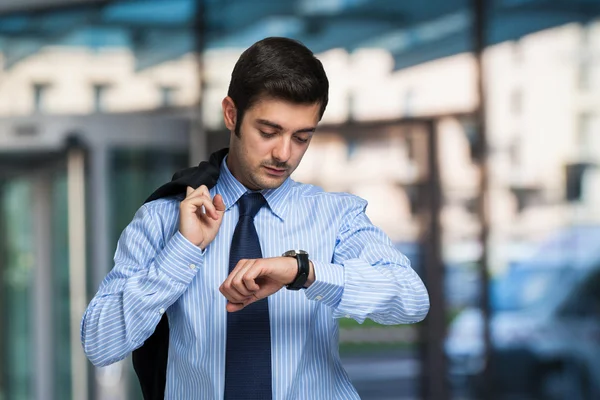Businessman checking time on watch Stock Image