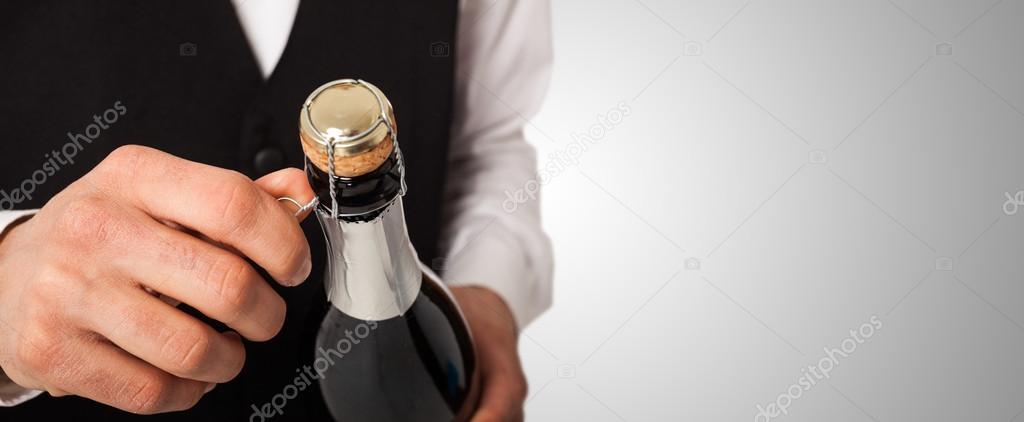 Waiter holding champagne bottle