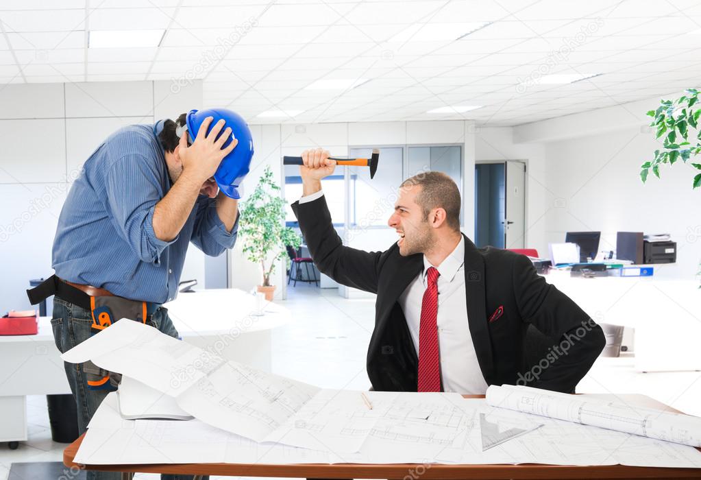 Angry boss attacking worker