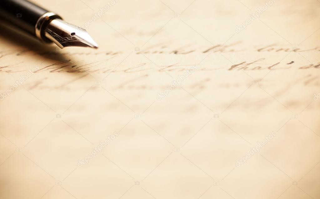 Fountain pen on an antique handwritten letter