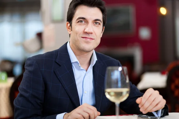 Handsome man eating at restaurant — Stock Photo, Image