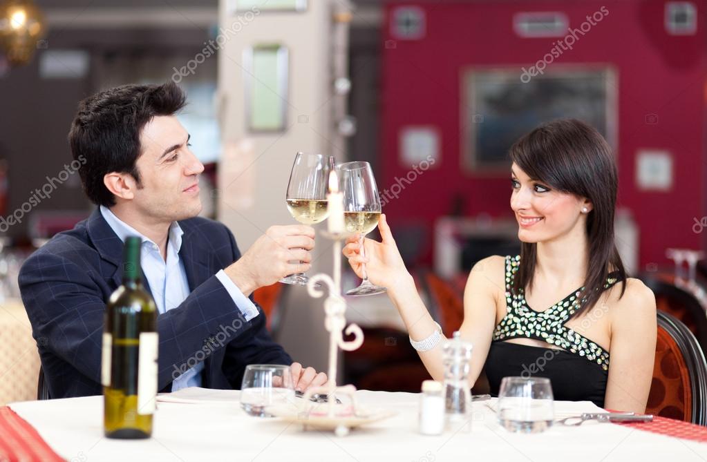 Happy couple toasting glasses