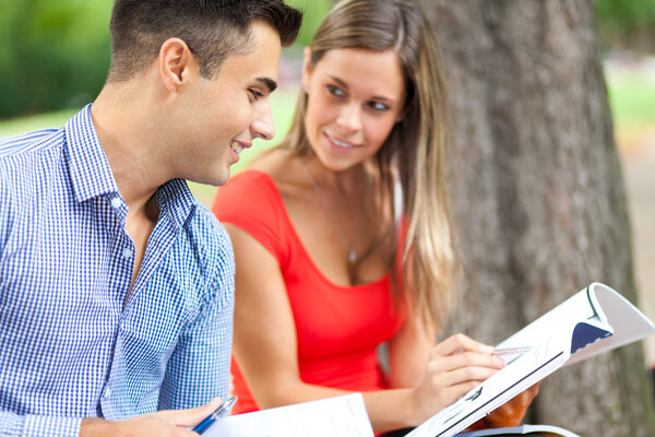 Two students reading in park