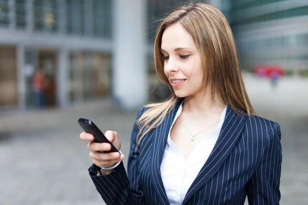 Kvinna som använder sin mobiltelefon — Stockfoto